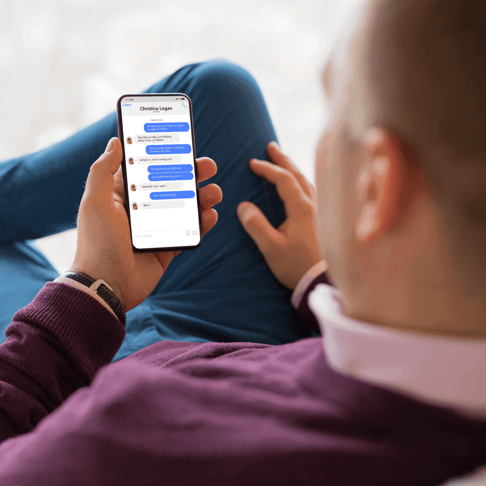 Facebook. Discussion Posts A man looking at a chat conversation on his smartphone